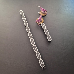 Segmented modular wargaming chain ruler in custom colors.