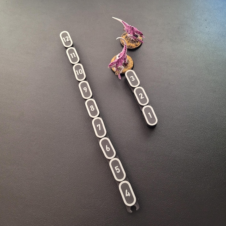 Segmented modular wargaming chain ruler in custom colors.