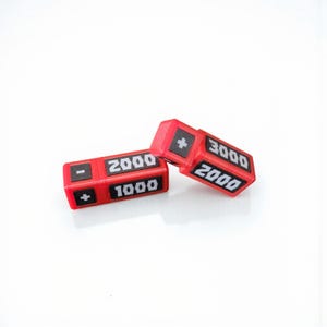 May include: Two red and black dice with white numbers and symbols. One die shows "2000", "1000", and a minus and plus sign. The other die shows "3000", "2000", and a plus sign. The dice are on a white background.