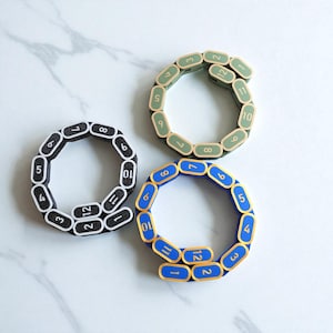 Segmented modular wargaming chain ruler in custom colors.