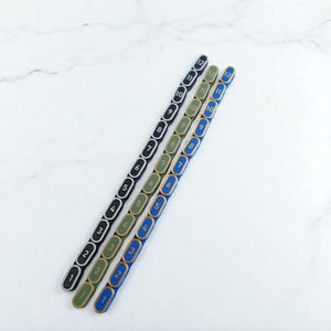 Segmented modular wargaming chain ruler in custom colors.