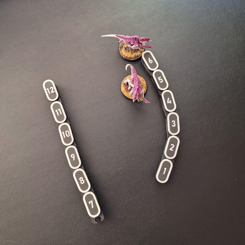 Segmented modular wargaming chain ruler in custom colors.