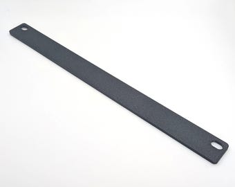 May include: A matte black metal bar with rounded corners and two holes, one at each end. The bar is rectangular and has a slightly textured surface, likely for grip or aesthetic purposes. The item is shown against a white background.