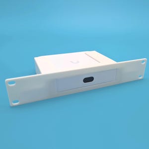 May include: A white electronic device with a rectangular body and a long, flat panel on the front. The panel has two holes on each end and a small, rectangular opening in the center. The device is set against a blue background.