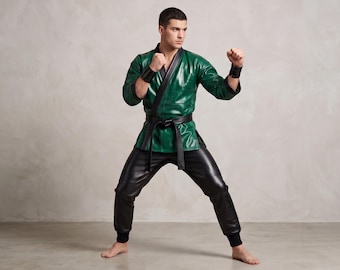 May include: A dark green faux leather martial arts jacket with black trim and a black collar, paired with black faux leather trousers and a black belt. The jacket features long sleeves with black cuffs and a wrap-style front closure.