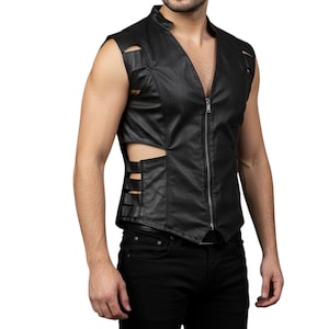 May include: Black leather vest with a zip-up front and cut-out details. The vest has a stand-up collar and is sleeveless. The model is wearing black jeans. The vest is a stylish piece of apparel.