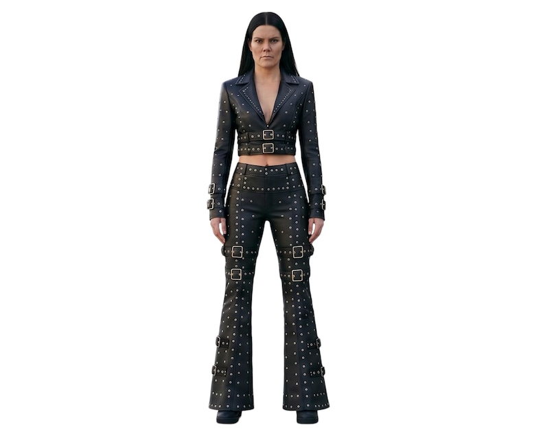 May include: A black leather two-piece set consisting of a cropped blazer and flared trousers. Both pieces feature silver-toned metal studs and multiple adjustable buckle straps on the sleeves, waist, and legs, creating a structured appearance.