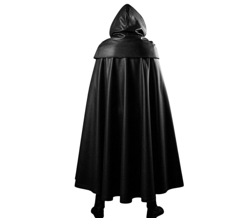 May include: A black hooded cloak, viewed from the back, with a smooth, leather-like texture. The cloak has a wide, flowing design, with a hood that drapes over the shoulders. The garment is suitable for cosplay or costume events.