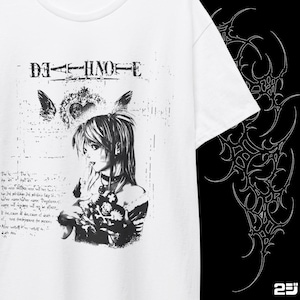 May include: White t-shirt featuring a black and white graphic of a female anime character with text that reads "DEATH NOTE". The design includes wings, a heart, and additional text. A black and white design is on the right side of the shirt.