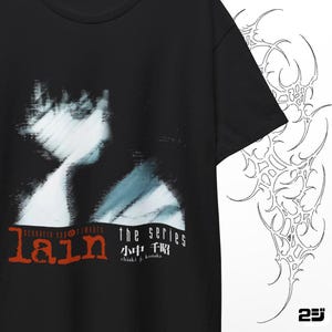 May include: Black t-shirt featuring a blurred image of a person with blue and white accents. The text "lain scenario experiments the series" is printed in red and white. A white abstract design is on the right side.