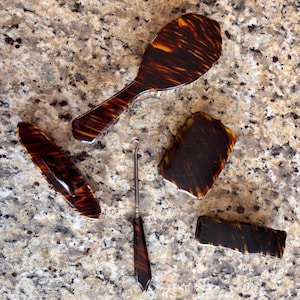 a vintage vanity set made from celluloid to imitate tortoiseshell~ 1920’s-1930’s
