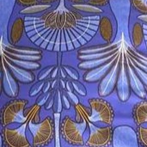 May include: Blue fabric with a repeating pattern of stylized trees with brown branches and white leaves. The background is a solid blue.