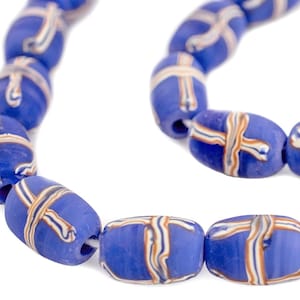 May include: A strand of blue oval beads with a cross-like pattern in white, orange, and cream. The beads are strung together on a white string, creating a necklace or bracelet.