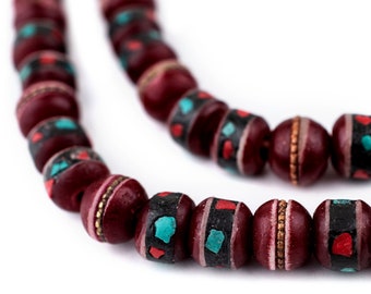 May include: A maroon beaded necklace with turquoise and red accents. The beads are round and have a glossy finish.