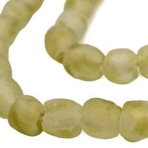 May include: A strand of pale green glass beads, each bead is slightly irregular in shape and has a matte finish.