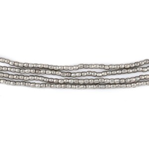 May include: A strand of silver beads, arranged in five rows, with a smooth, slightly textured finish.