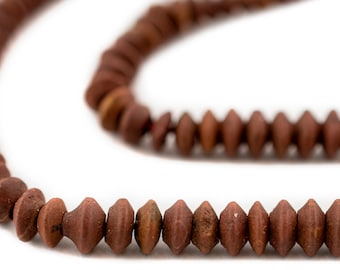 May include: A strand of brown clay beads with a faceted, diamond-shaped design. The beads are strung on a cord and are arranged in a loose, flowing pattern.