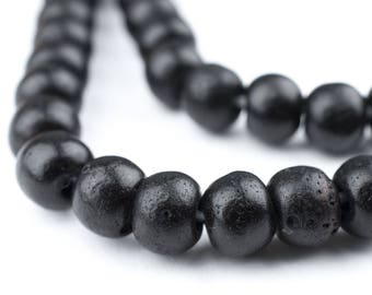 May include: A black beaded necklace with round beads. The beads are smooth and have a matte finish.
