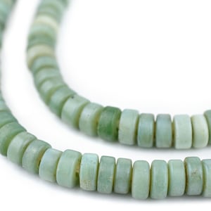 May include: A strand of pale green glass beads, each bead is a cylinder with rounded edges.
