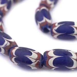 May include: A strand of blue and white glass beads with a red swirl pattern. The beads are oval shaped and have a glossy finish.