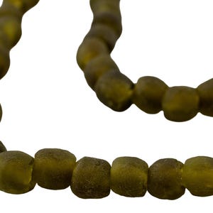 May include: Olive green beaded necklace with a matte finish. The beads are irregularly shaped and strung together, creating a unique and earthy aesthetic. The necklace is displayed against a white background.