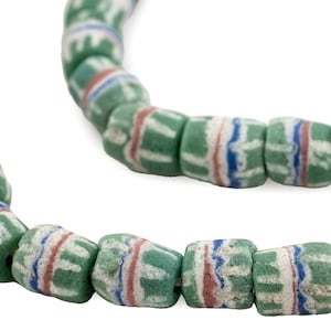 May include: Strand of green, white, red, and blue striped beads. The beads are barrel-shaped and appear to be made of glass or a similar material. The beads are strung on a white cord, and the background is white.