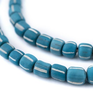 May include: Close-up of a strand of turquoise beads with white stripes. The beads are cylindrical and have a slightly irregular shape. The background is plain white, highlighting the beads' color and design.