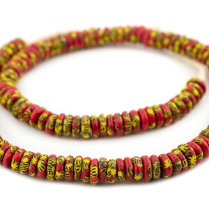May include: A strand of red and yellow beads with a black geometric pattern. The beads are round and have a slightly flattened shape.