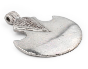 May include: A silver-colored axe pendant with a detailed design. The pendant has a loop at the top for attaching to a chain or cord.