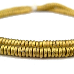 May include: A strand of gold-colored metal beads. The beads are round and have a slightly textured surface.