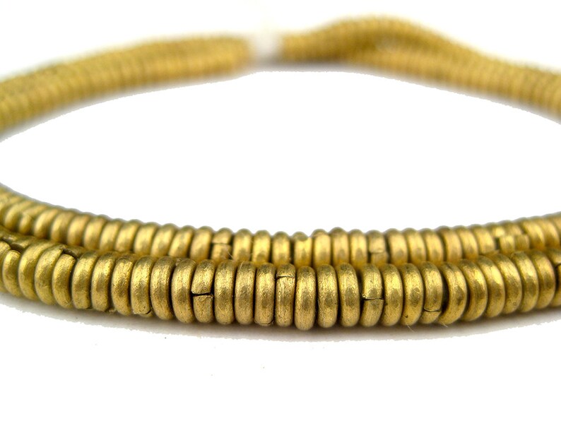 May include: A strand of gold-colored metal beads. The beads are round and have a slightly textured surface.