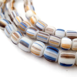 May include: A strand of white glass beads with brown, blue and yellow stripes. The beads are round and have a smooth, polished finish.