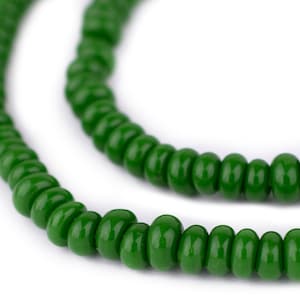 May include: A strand of green glass beads, strung together to form a necklace or bracelet. The beads are round and have a glossy finish.