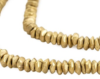 May include: A strand of gold-colored metal beads. The beads are faceted and have a rough, hammered texture.