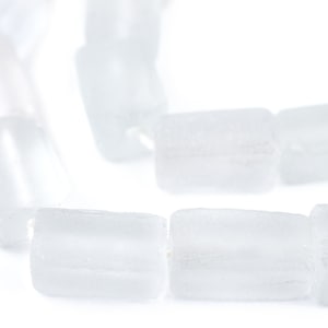 May include: A strand of opaque white glass beads, each bead is a rectangular prism shape.