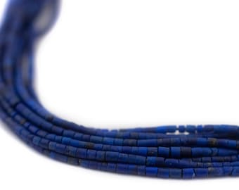 May include: A strand of dark blue lapis lazuli beads, each bead is a cylinder shape with a slightly rough texture.
