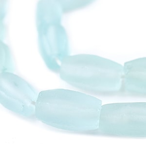 May include: A strand of light blue glass beads, each bead is oval shaped and has a frosted finish.