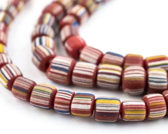 May include: Close-up of a strand of colorful, striped beads. The beads are primarily red with horizontal stripes of white, yellow, blue, and other colors. The beads are strung together on a red cord, creating a decorative accessory.