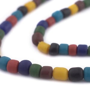May include: A necklace featuring a string of colourful, square beads. The beads are in shades of yellow, black, blue, red, green, and brown. The necklace is set against a white backdrop.