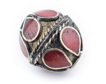 May include: A round, red and gold bead with intricate metalwork and a braided design. The bead is made of metal and has a red enamel finish.