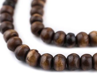 May include: Close-up of two strands of dark brown wooden beads. The beads are round and have a natural wood grain texture. The beads are strung together, creating a necklace or bracelet.