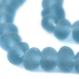 May include: A strand of light blue glass beads with a frosted finish.