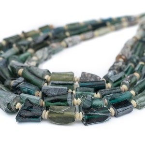 May include: A multi-strand necklace made of dark green and light blue glass beads. The beads are irregular in shape and size, and some have a slightly iridescent finish.