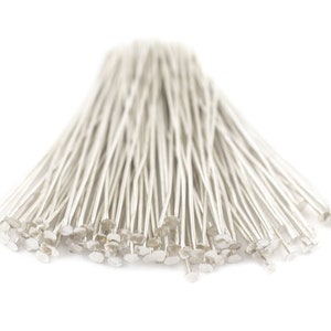 May include: A bunch of silver head pins, used for jewelry making and crafts.