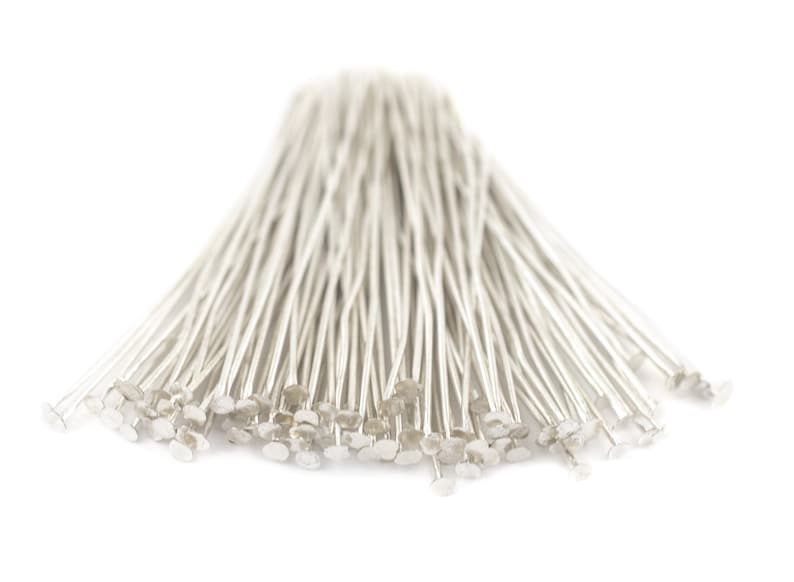 May include: A bunch of silver head pins, used for jewelry making and crafts.
