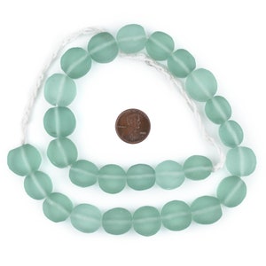 May include: A strand of light green glass beads, approximately the size of a US penny, strung on a white cord.