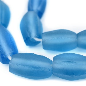 May include: A strand of light blue glass beads, each bead is oval shaped and has a frosted finish.