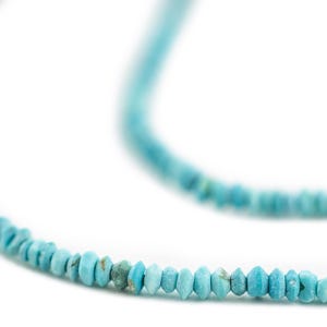 May include: A strand of turquoise beads, each bead is a light blue color and has a faceted shape.
