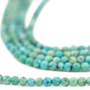May include: Strands of turquoise gemstone beads in various shades of blue and green. The beads are round and faceted, creating a sparkling effect. The beads are strung together, ready for jewelry making.