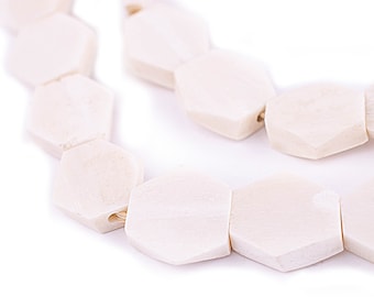 May include: A strand of off-white hexagonal beads strung together with a thin, natural fiber cord.